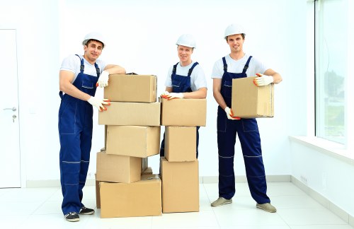 Workers following safe storage procedures in a warehouse environment